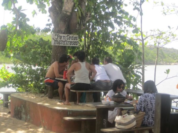 Locals eating food by the water